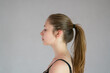 Profile portrait of a pretty teenage girl with ponytail hair