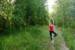 © dron285 - Brunette in the Park (forest) doing yoga and stretching. The girl is going to do sports in the fresh air. Concept of fitness, sports and healthy lifestyle.