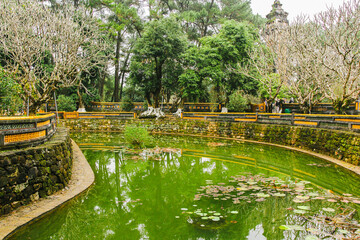 Colorful green park with a bridge above the lake, Vietnam