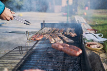 Preparation Of Barbecue On Bacon And Sausage Grill