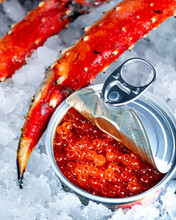 Red Caviar Lies On Ice With Crab Claws