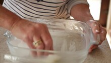 Greasing A Glass Heat Resistant Dish In Preparation For Cooking