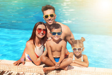 Canvas Print - Happy family in swimming pool on sunny day