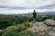 © Alvaro Sanchez/ADDICTIVE STOCK - Back view of faceless male in casual outfit standing on edge of cliff and enjoying amazing scenery of mountain range against cloudy sky in Alicante in Spain
