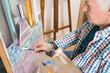 © Alvaro Sanchez/ADDICTIVE STOCK - Aged man painting picture with brush