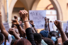 People Raising Fist With Unfocused Background In A Pacifist Protest Against Racism Demanding Justice