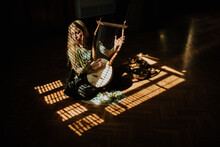 Lady Playing Lyre In Dark Room