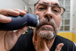 © Paco Sinisterra/ADDICTIVE STOCK - Mature man shaving with electric razor