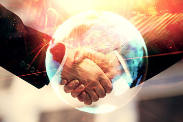 Double exposure of business theme hologram and handshake of two men. Success concept.