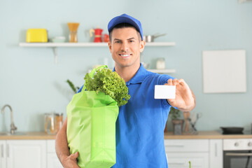 Wall Mural - Delivery man with food from market and business card in kitchen