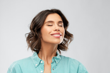 Sticker - people concept - portrait of happy smiling young woman in turquoise shirt breathing over grey background