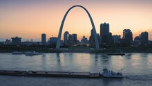 Aerial: The Gateway Arch, Barge On The Mississippi River & Downtown St Louis At Sunset, Missouri, USA