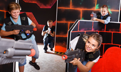 Wall Mural - Kids and adults playing lasertag