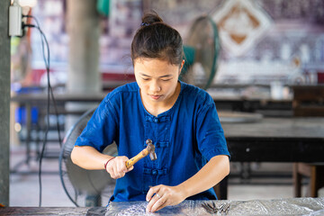 Silverware making. Thai craftman are making silverware. The original of the silver craftsmen on Wua Lai road, Chiang Mai. Thailand.