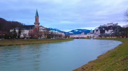 Poster - The cloudy evening in Salzburg with a view on Salzach river, Hohensalzburg fortress, dominating the skyline and bell tower of Protestant parish Christ church and Alps on background, Austria