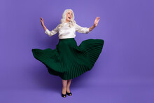 Full Body Photo Of Attractive Mature Grey Haired Lady Dancing Retro Party Raise Hands Modern Movement Excited Wear White Blouse Green Long Skirt Flying Isolated Purple Color Background