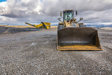Wall Mural - Excavator and heavy machinery for processing rock and stone in a quarry