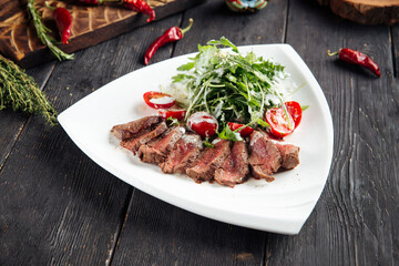 Wall Mural - Gourmet roast beef with arugula and tomato salad