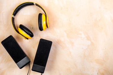 listen to music concept. audio speakers and headphones on desk copy space