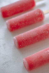 Pink fruit ice sorbet on a white background. Stick ice cream. Close up