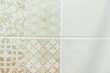 White ceramic tile on the wall with a beautiful floral beige pattern
