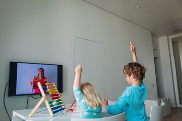 Wall Mural - kids learning at home, boy and girl doing online math lesson