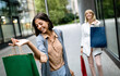 © NDABCREATIVITY - Beautiful happy women with shopping bags walking at the mall