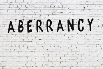 Word aberrancy painted on white brick wall