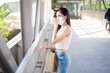 © tonefotografia - Young woman with face mask is standing outdoor City