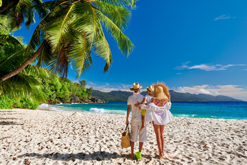 Wall Mural - Family with three year old boy on beach. Seychelles, Mahe.