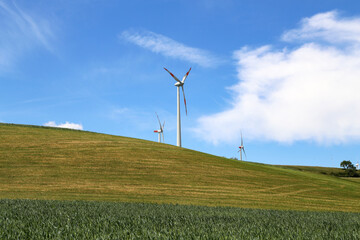 Windmills against the blue sky. Alternative source of energy