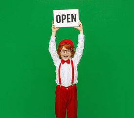 Happy ginger boy showing Open sign.