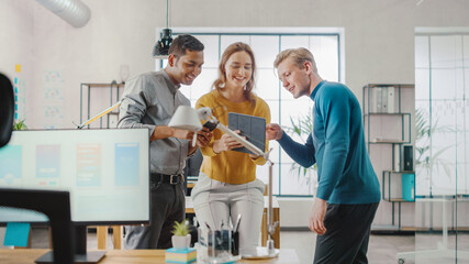 Poster - In the Office: Three Diverse Start-up Entrepreneurs Have Meeting and Discussion about the Project. Share Touch Screen Digital Tablet and Smartphone Screens.Young Professionals Smile and Joke Around.