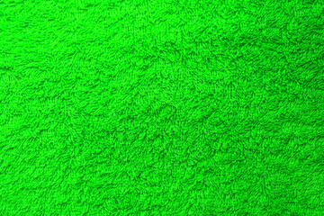 Wall Mural - Terry towel texture of bright green color background. Soft woven terry cloth material background, bright vibrant green colour towel structure with no text