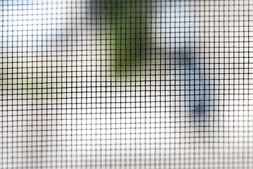 Mosquito net on the window closeup. Protection of the house from small insects. Background. Selective focus