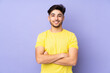 © luismolinero - Arabian handsome man over isolated background with arms crossed and looking forward