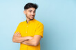 © luismolinero - Arabian handsome man over isolated background with arms crossed and happy