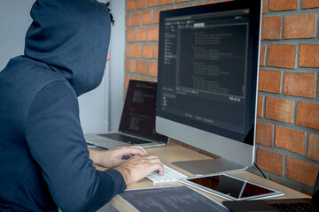 Leinwandbilder - Computer hacker or cyber attack concept, Dangerous hooded hacker using multiple computers typing bad data into online system the access with a virus to infect steal information