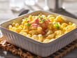 mac and cheese in dish with scallions and bacon garnish