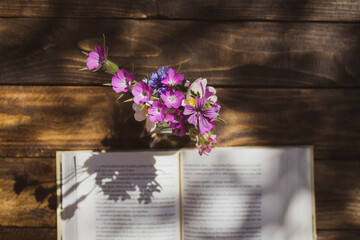 open book and vase on wooden table