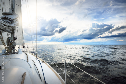Fotografía Blue yacht sailing in an open sea on a sunny summer day