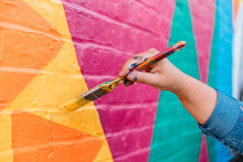 Artist Painting A Wall With A Brush