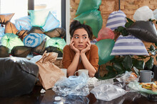 Asian Woman Spending Time At Her Apartment Full Of Rubbish