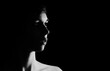 © Photography by Adri - Black and white backlit portrait of young woman on black background