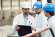 © auremar - three workers in white jackets looking at laptop
