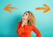 © alphaspirit - Confused woman have to choose the right arrow to follow. Concept of options, confusion, decision.