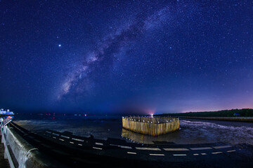 Wall Mural - the milky way galaxy on bang pu samut prakan province, thailand.long exposure photograph, with grain