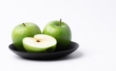 Wall Mural - Fresh green apples in a dish on white background