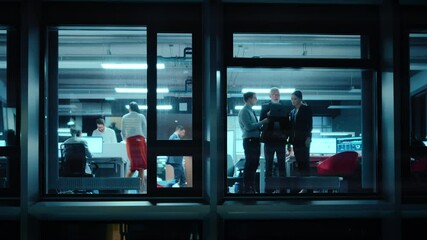 Poster - Footage from Outside the Window: Daily Meeting in the Office. Senior Manager Explaining New Business Strategy to Young Financial Specialists on a Laptop Computer while Standing Next to a Window.