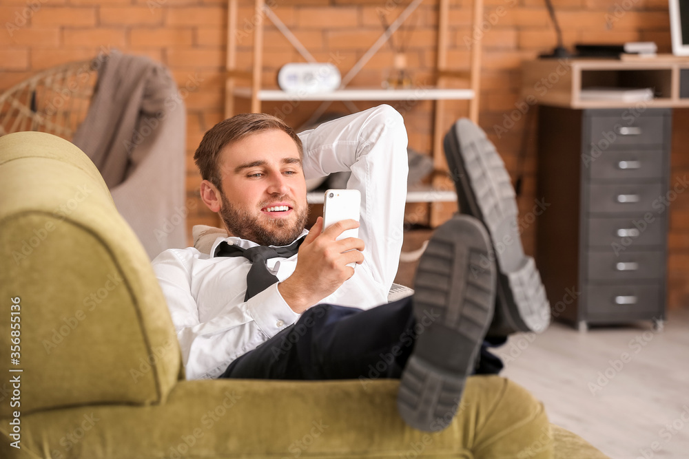 Young businessman resting at home after long working day